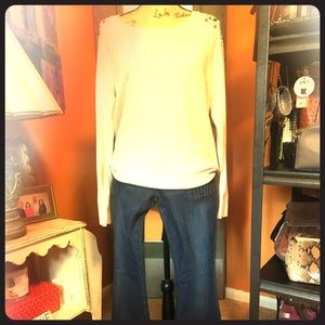 Sweater with beaded shoulders.